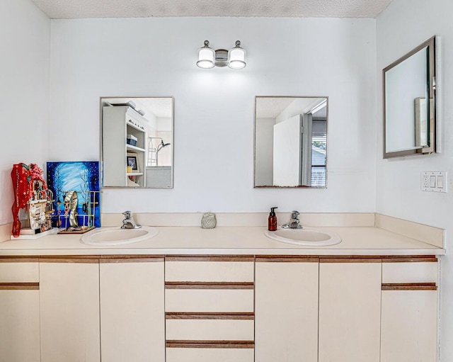 bathroom with vanity and a textured ceiling