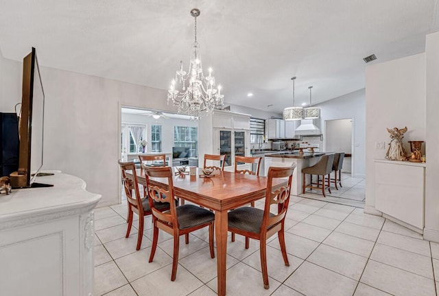 dining space with vaulted ceiling and light tile patterned floors