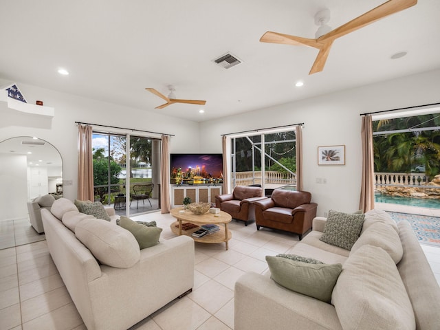 tiled living room with ceiling fan