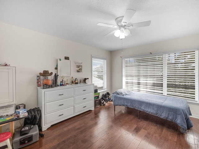 bedroom featuring ceiling fan and dark hardwood / wood-style flooring