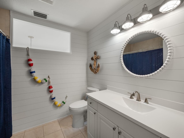 bathroom with tile patterned flooring, vanity, and toilet