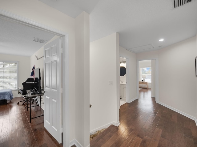 hallway with dark wood-type flooring