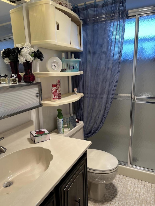 bathroom with vanity, an enclosed shower, and toilet