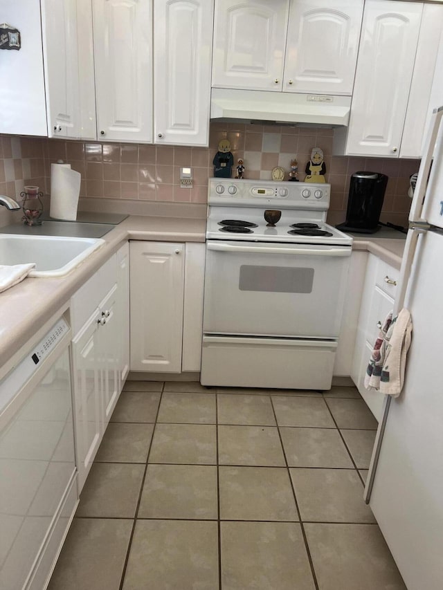 kitchen with white cabinetry, white appliances, and sink