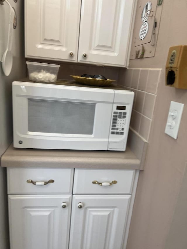 room details with white cabinets and backsplash