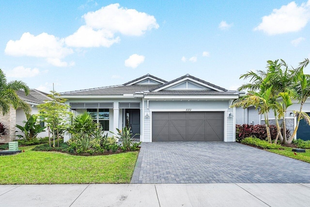 view of front of house with a garage and a front lawn