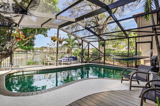 view of swimming pool featuring a patio and a lanai