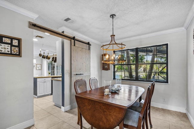 dining room featuring light tile patterned flooring, ornamental molding, a barn door, and a textured ceiling