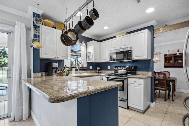 kitchen featuring sink, white cabinetry, ornamental molding, appliances with stainless steel finishes, and kitchen peninsula