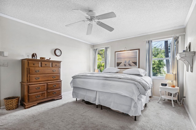 carpeted bedroom with ornamental molding, ceiling fan, and a textured ceiling