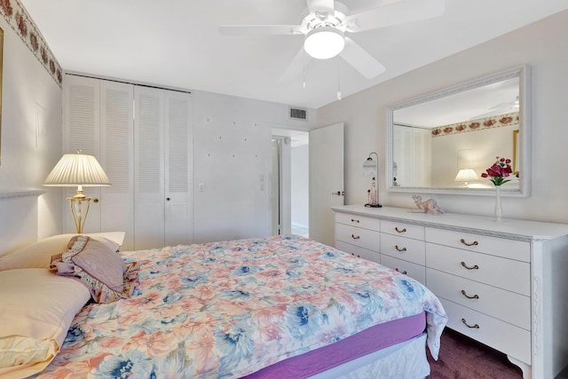 carpeted bedroom featuring a closet and ceiling fan