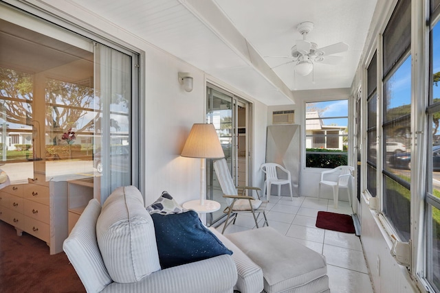 sunroom featuring ceiling fan