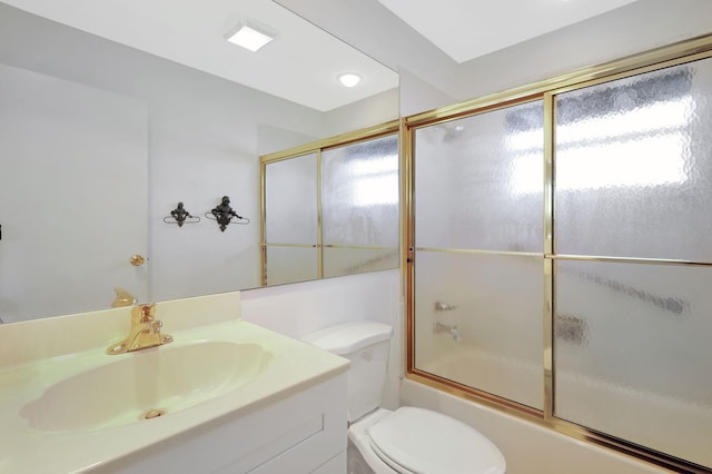 full bathroom with vanity, enclosed tub / shower combo, and toilet