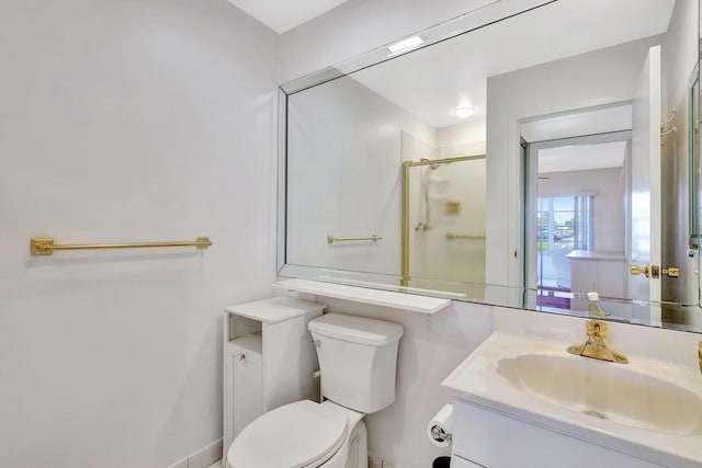 bathroom with an enclosed shower, vanity, and toilet