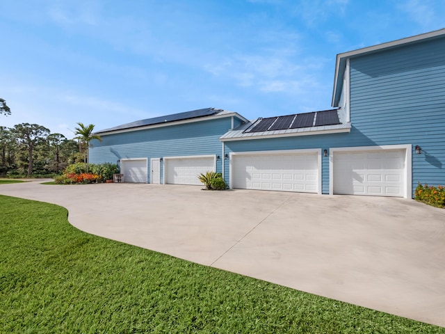 view of front facade with a garage and solar panels