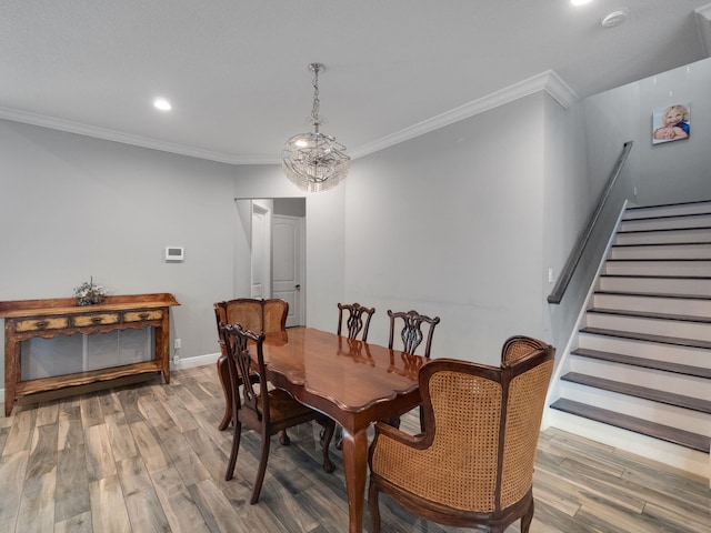 dining space with hardwood / wood-style floors and crown molding