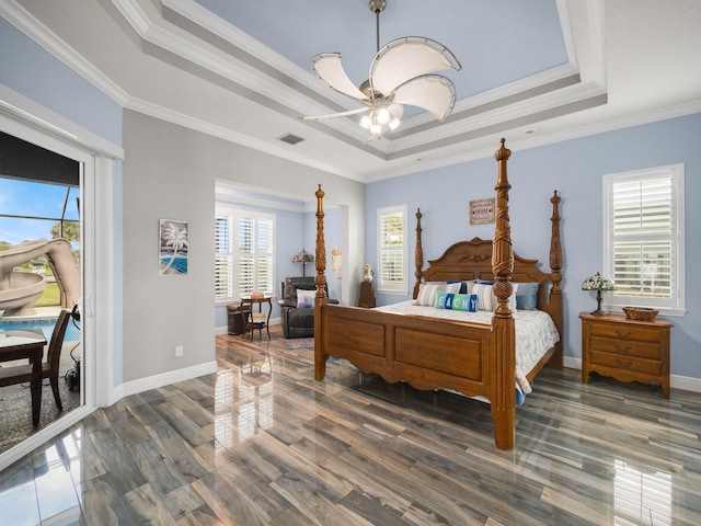 bedroom featuring crown molding, access to outside, dark hardwood / wood-style flooring, and a tray ceiling