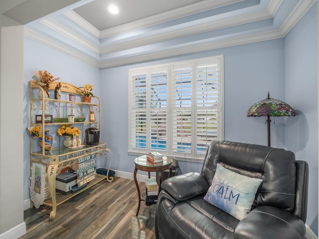 living area with crown molding, a tray ceiling, and dark hardwood / wood-style floors