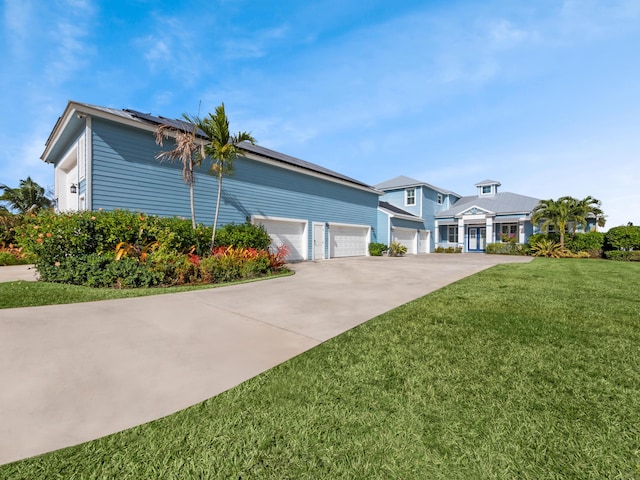 view of front of property with a garage and a front lawn