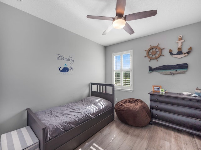 bedroom with ceiling fan and light wood-type flooring