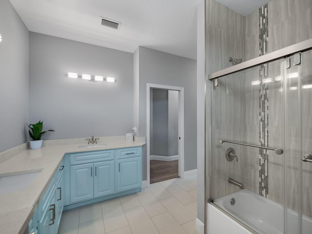 bathroom with vanity, tile patterned floors, and enclosed tub / shower combo