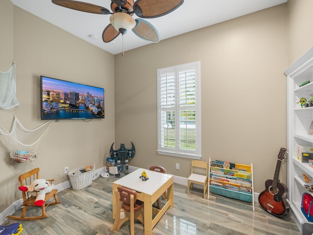 game room featuring wood-type flooring and ceiling fan