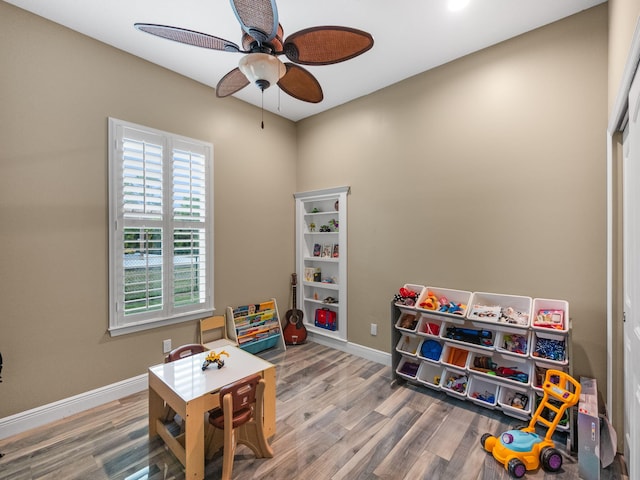 playroom with wood-type flooring and ceiling fan