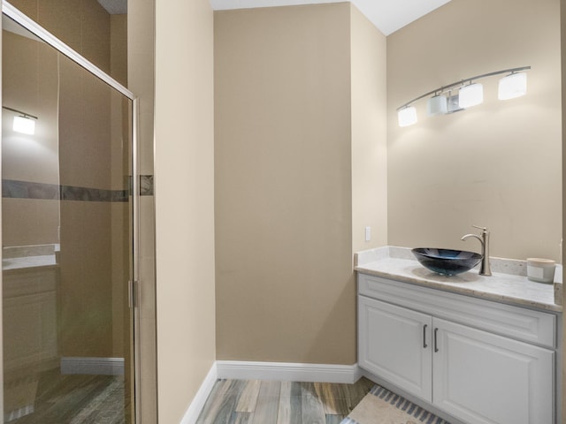 bathroom featuring vanity, wood-type flooring, and walk in shower