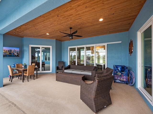 living room featuring carpet floors, wooden ceiling, and ceiling fan