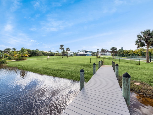 dock area featuring a water view and a lawn