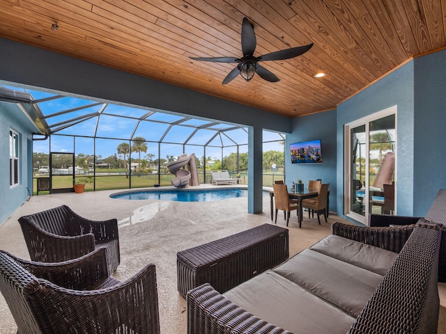 view of patio / terrace with an outdoor hangout area, ceiling fan, and glass enclosure