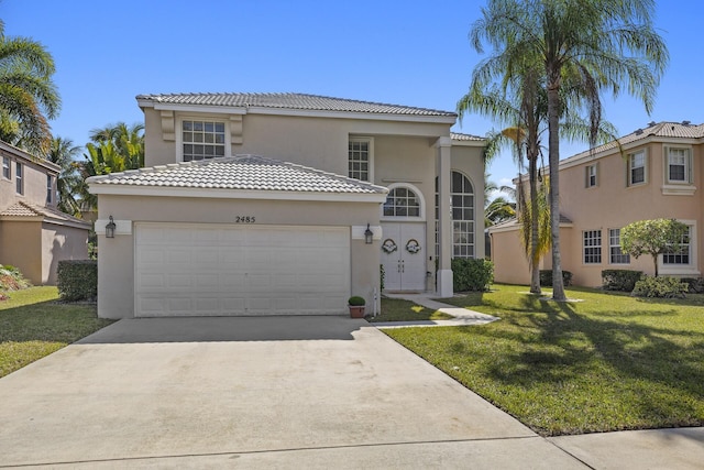 mediterranean / spanish-style home featuring a garage and a front lawn