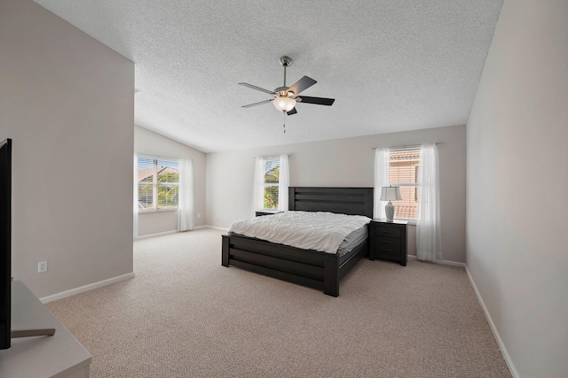 carpeted bedroom featuring ceiling fan, lofted ceiling, and a textured ceiling