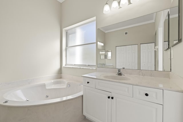 bathroom featuring vanity, a bathing tub, and crown molding