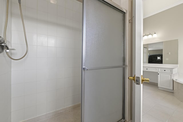 bathroom featuring independent shower and bath, vanity, and tile patterned floors