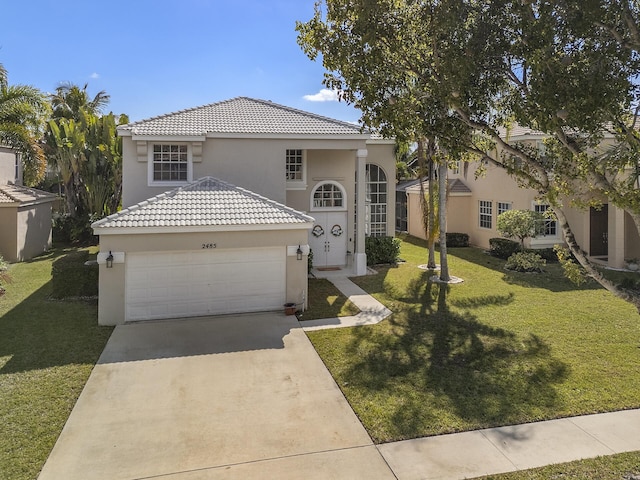 mediterranean / spanish-style house featuring a garage and a front yard