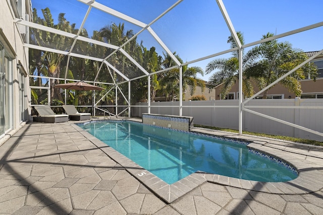 view of pool featuring a patio area and glass enclosure