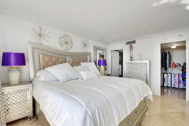 bedroom with ornamental molding and a spacious closet