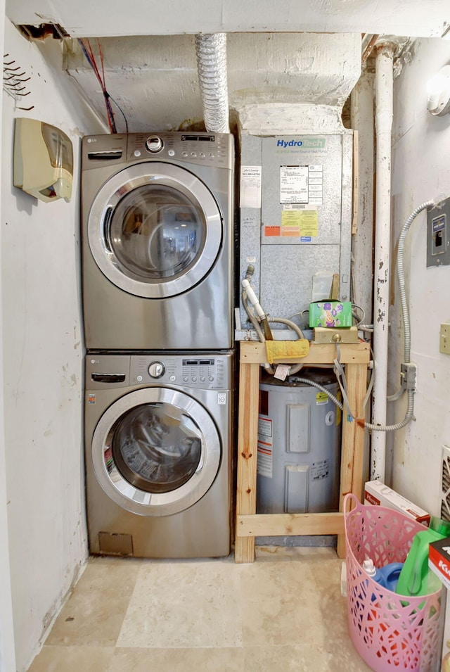 clothes washing area featuring stacked washer and dryer