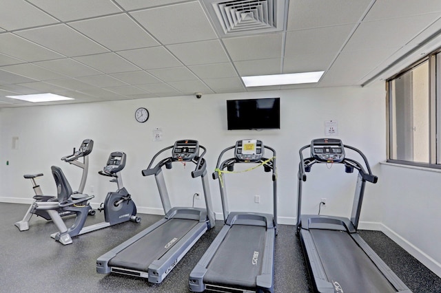 gym with a paneled ceiling