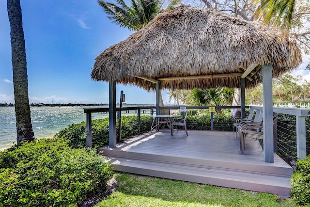 wooden terrace with a water view and a gazebo