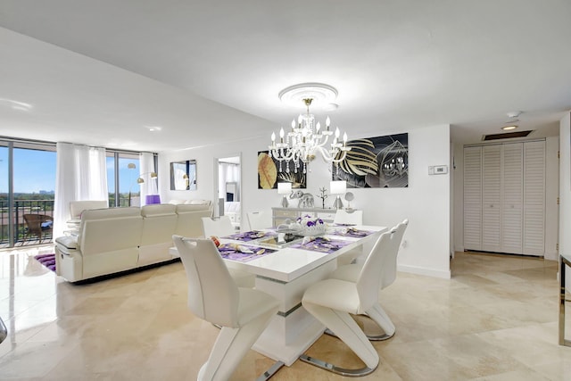 dining space featuring floor to ceiling windows and a chandelier