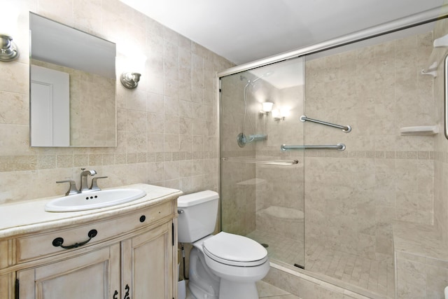 bathroom with vanity, toilet, an enclosed shower, and tile walls