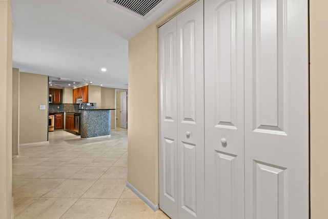 hall featuring light tile patterned flooring