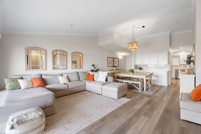 living room featuring ornamental molding and light hardwood / wood-style floors