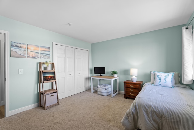 bedroom with a closet and light carpet