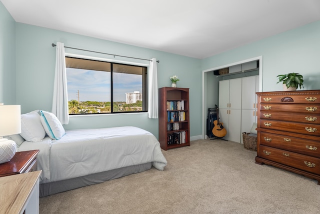 bedroom featuring light carpet and a closet