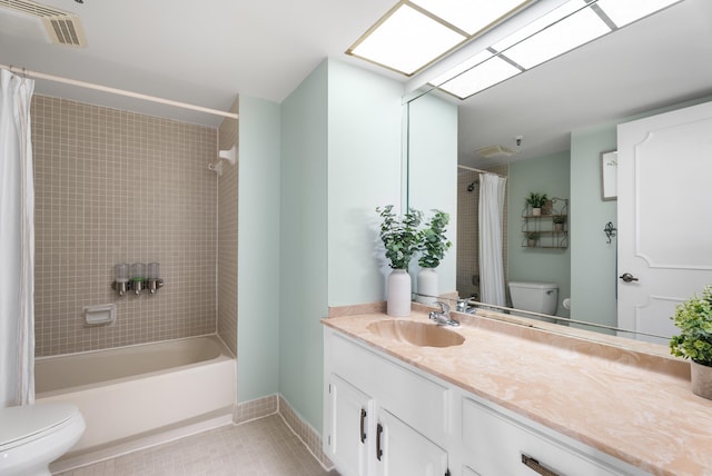 full bathroom featuring shower / tub combo, vanity, a skylight, and toilet