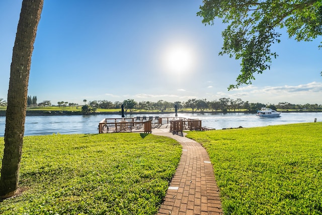 view of dock featuring a yard and a water view