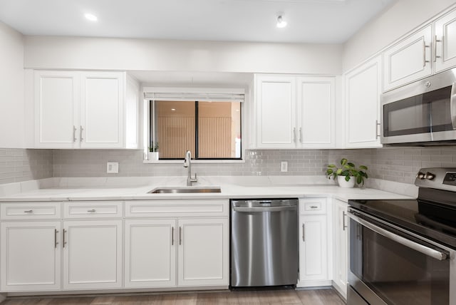 kitchen with white cabinetry, sink, and stainless steel appliances